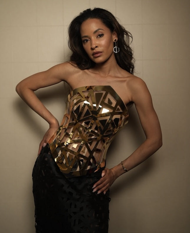 Model and actress Valerie Kinley wears the Pragna 18-karat gold corset from Naude Bourn’s État d’Or Collection, paired with Know You Studs and Illuminate You Dangles in Bravura Yellow, captured in a high-fashion editorial at the iconic Hotel Martinez during Cannes 2025.